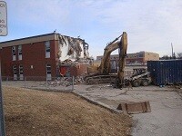 Picture of construction equipment tearing down a building