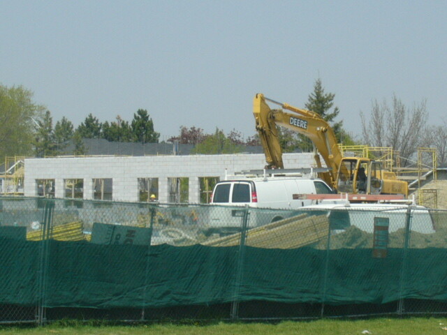 Picture of a building with construction equipment in front