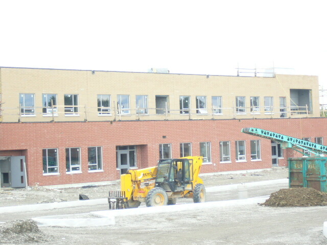 Picture of a building with construction equipment in front